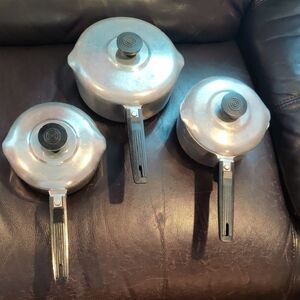 Set of Three Silver Saucepans with Black Handles